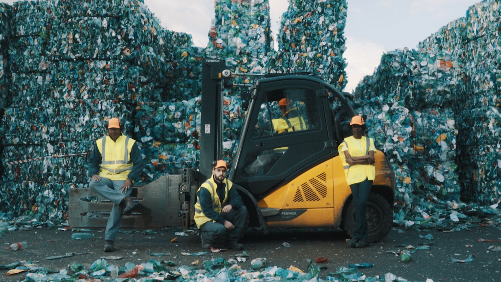 Men in front of a pile of garbage